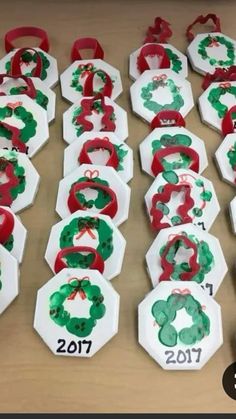 some paper plates with christmas wreaths on them and numbers in the shape of snowflakes