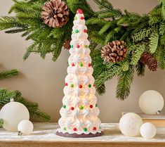 a christmas tree made out of meringue and candy canes on a table