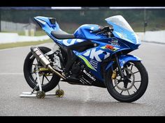 a blue motorcycle parked on top of a parking lot