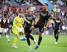 the soccer players are celebrating their goal in front of an audience at a sporting event