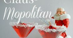 two martini glasses filled with red liquid and topped with santa clause