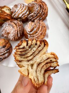 a person holding a pastry in their hand