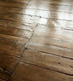 an old wooden floor with peeling paint on it