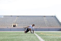 a man kneeling down on top of a soccer field