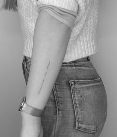 a woman's arm with a small tattoo on the left side of her right arm