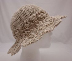 Crocheted wide brim sun hat to keep the damaging UV rays off the face. Beautiful open-work design on brim and part of body of hat. Beige in color. Sized for average women's head size.   Made with mercerized Egyptian cotton which is the finest cotton you can lay your hands on! Mercerized cotton has a gentle sparkle when knitted or crocheted and contains long fibers, making it extremely strong, wearable and durable. Pattern is based on a Drop's design.  Sized to fit average women's head size: 22 1 Bohemian Cream Wide Brim Sun Hat, Cream Bohemian Wide Brim Sun Hat, Bohemian Brimmed Cream Sun Hat, Cream Handmade Sun Hat With Curved Brim, Cream Sun Hat With Handmade Curved Brim, Handmade Cream Sun Hat With Curved Brim, Bohemian Cream Crochet Hat With Short Brim, Cream Bohemian Crochet Hat With Short Brim, Bohemian Cream Bucket Hat With Short Brim