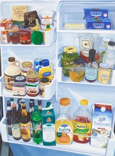 an open refrigerator filled with lots of different types of condiments and sauces