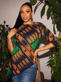 Show off your chic Afrocentric side with this 3/4-Sleeve top. This gorgeous African print women’s 3/4-sleeve top features a right-side slant for a flattering look. You can wear it with a variety of bottoms for versatile looks. Pair it with skinny jeans and heeled sandals for a stylish getup. DESCRIPTION:  * Standard Fit African print top * High Low (Slanted on the right side) * Unlined * Invisible back zip * 3/4 Sleeves * Sleeve length 15 inch * 100% cotton * Model is 5'7 and wears US Size S * M African Print Top, African Tops For Women, Ankara Blouse, African Blouses, African Tops, African Print Tops, African Skirts, Trendy Tops For Women, African Design