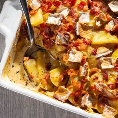 a casserole dish filled with potatoes and meat