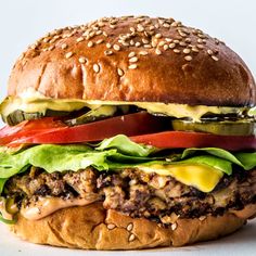 a large hamburger with lettuce, tomato and cheese