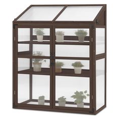 a brown and white display case with potted plants in it's glass doors