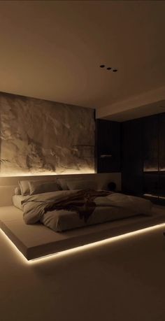 a large bed sitting in the middle of a bedroom next to a wall with lights on it