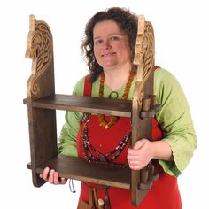 a woman in an apron holding a wooden shelf