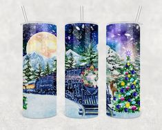 three candles decorated with christmas scenes and trees