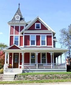 a red and white house with a clock tower