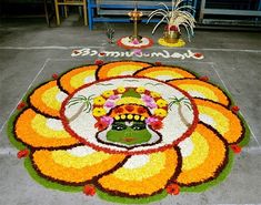 a large flower arrangement on the ground in front of a sign that says sri lankanna