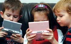 three children are looking at their electronic devices