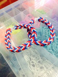 an assortment of colorful bracelets sitting on top of a plastic container