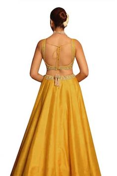 Mustard padded blouse with floral, dabka, zardozi, pearl, kirandori embroidery. Paired with an attached cancan lehenga with placement embroidery using similar work and dupatta with embroidered border. - Aza Fashions Fitted Gold Art Silk Gown, Fitted Gold Gown In Art Silk, Festive Lehenga With Fitted Bodice And Traditional Drape, Festive Reception Sets With Fitted Bodice, Festive Lehenga With Zari Work And Fitted Bodice, Traditional Silk Gown With Unstitched Blouse, Festive Lehenga With Fitted Bodice, Fitted Sleeveless Raw Silk Choli, Fitted Sleeveless Gown With Zari Work