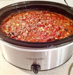 a crock pot filled with meat and vegetables