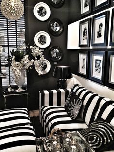 a black and white living room with pictures on the wall