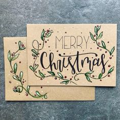 two christmas cards sitting on top of each other with the words merry christmas written in black ink