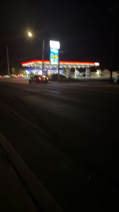 the gas station is lit up at night