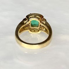 A delightful candy colored vintage natural Colombian emerald ring featuring a bright and lustrous emerald cut center stone weighing 1.50 carats surrounded by a medley of round and baguette white diamonds weighing 0.64 carats. Complimentary resizing is available up to 3 sizes larger or smaller than the stated size. WEB ID: 3B98 Classic Gold Emerald Ring With Baguette Diamonds, Heirloom Green Diamond Ring Baguette Cut, Heirloom Green Diamond Ring With Baguette Cut, Heirloom Green Baguette Cut Diamond Ring, Heirloom Green Baguette-cut Diamond Ring, Classic Green Emerald Ring With Baguette Diamonds, Classic Yellow Gold Emerald Ring With Baguette Diamonds, Heirloom Green Baguette Cut Emerald Ring, Classic Green Diamond Ring With Baguette Diamonds