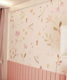 a pink room with flowers painted on the wall and a radiator in the corner