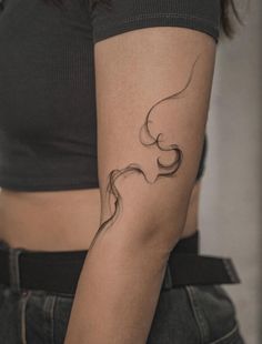 a woman's left arm with a tattoo on it, which is shaped like a wave