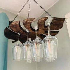 a chandelier with five wine glasses hanging from it