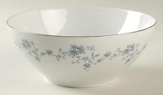 a white bowl with blue flowers on it