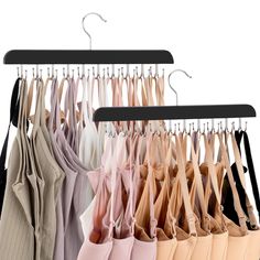 an assortment of women's bras hanging on clothes hangers with rubber clips