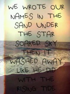 a poem written in black ink on a beach with the ocean and sky behind it