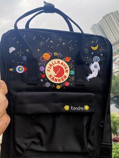 Welcome to our charming collection of hand-embroidered Fjallraven Kanken backpacks, meticulously crafted with love and precision. Elevate your style and stay organized on-the-go with these premium quality backpacks available in two convenient sizes:  - Medium (27x38x13cm)  - Large (32x42x13cm) + Key Features: - Hand-Embroidered Excellence: Each Fjallraven Kanken backpack is adorned with exquisite hand-embroidery, creating a unique and exclusive piece that sets you apart from the crowd. - Premium Astronaut Backpack, Planets In The Solar System, Medieval Party, Backpack Charm, The Solar System