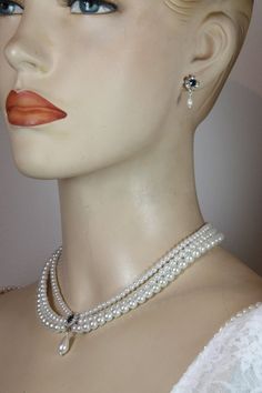 Amazing and stunning  bridal set of choker necklace and earrings for the bride features triple strands of white pearls and blue Sapphire Swarovski stone in the middle surrounded with clear Swarovski zirconium and dangling white vintage drop pearl below.This beautiful necklace can fit any style of white/ivory wedding dress.The shape is vintage Victorian and fits so beautiful on your neck. The earrings are extremely comfortable -  A perfect necklace and earrings for the bride or for another specia Luxury Bridal Necklace With Round Beads For Festive Occasion, Earing And Necklace Set For Wedding Pearl, Luxury Pearl Bridal Necklace With Pearl Drop, Luxury Round Pearl Bridal Necklace, Luxury Classic Bridal Necklace With Pearl Drop, Luxury Wedding Necklace With Round Beads, Traditional Luxury Bridal Necklace With Polished Beads, Luxury Pearl White Bridal Necklace With Round Beads, Luxury Beaded Bridal Necklace With Round Beads