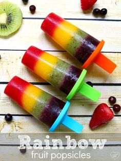 three popsicles with fruit in them sitting on a table