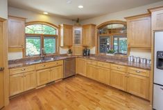 an empty kitchen with wood floors and wooden cabinetry on the walls is pictured in this image