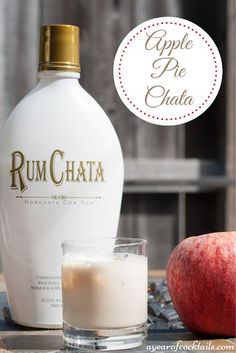 a bottle of rumchata next to an apple and a glass with milk in it