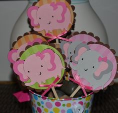 cupcake toppers with elephants on them in a bucket