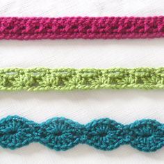 three crochet strips are lined up on top of each other in different colors