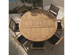 an overhead view of a wooden table and chairs on a patio with tile flooring