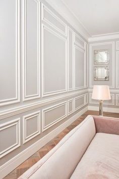 an empty room with white walls and wood flooring on the wall is pictured in this image