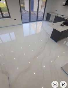 a kitchen with white marble floors and cabinets