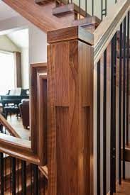 a wooden stair case next to a set of stairs