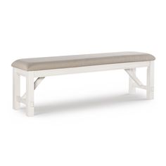 a white bench with a cushion on it