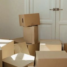 several cardboard boxes stacked on top of each other in front of a white closet door