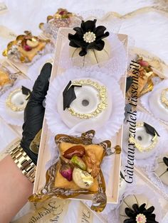 a table topped with lots of different types of cakes and donuts on top of each other