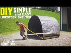 a man is pushing a large object in the dirt with words over it that read diy simple and easy livestock shelter