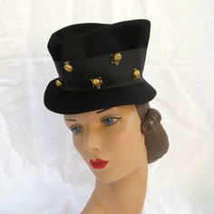 Classic 1940's top hat with a feminine flare. Made in 100% wool felt with a high crown and an asymmetrical brim. Trimmed with a wide black grosgrain ribbon around the crown that is adorned with gold flower shaped buttons. Interior crown has black grosgrain ribbon and an elastic to hold the hat in place. **Some photos have a camera flare spot which is not a flaw in the felt. **Ask me about International shipping rates. Label:  Merrimac Hat Corp.  Made in USA Condition:  Excellent.  Looks barely w Adored Vintage, The Mad Hatter, Equestrian Riding, Vintage Hats, Curated Vintage, Black Felt, Small Photos, Hawaiian Print, Knit Sweater Dress